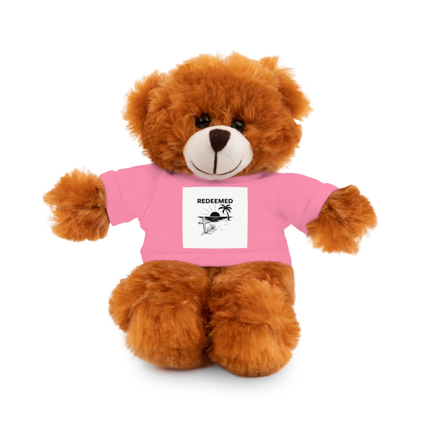 Brown teddy bear wearing a pink shirt with a printed design on a white background
