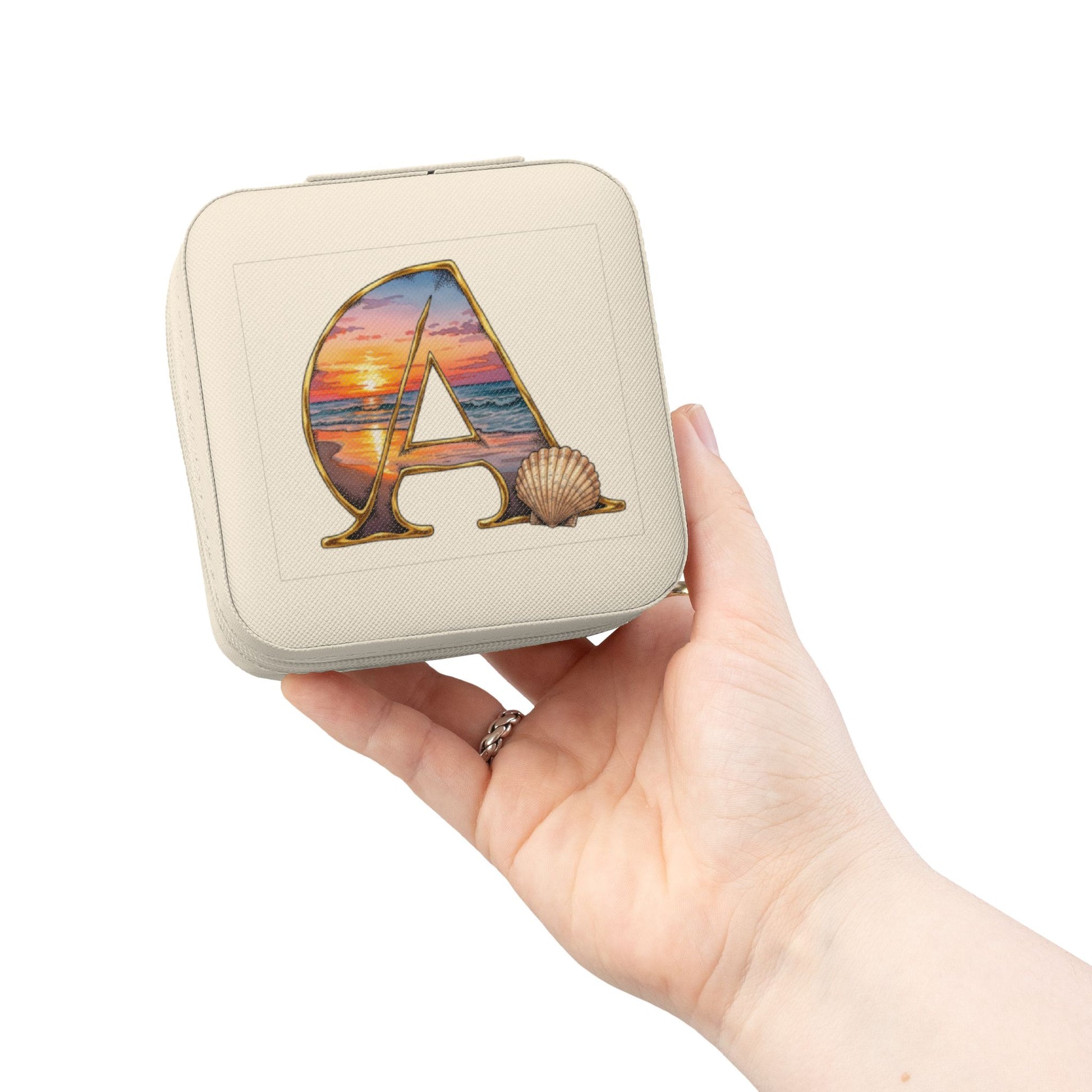 Beige square pouch with a colorful 'A' design held in a hand against a white background