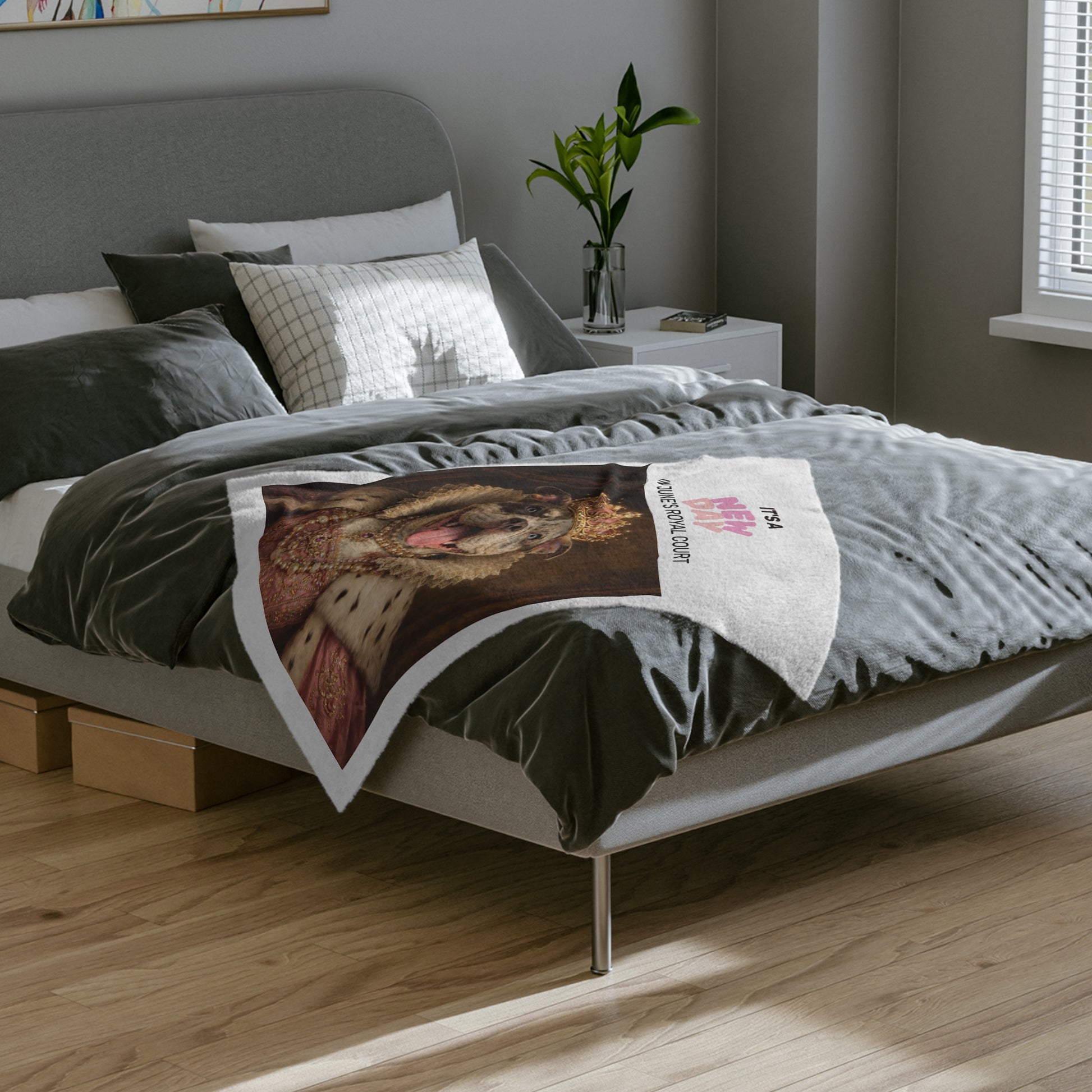 Bed with gray bedding and a blanket featuring a Queen June royal portrait design in a bedroom setting.