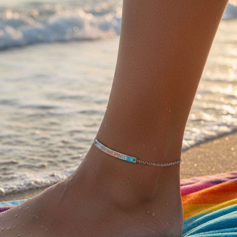 Anchored bracelet on a foot with ocean waves in the background