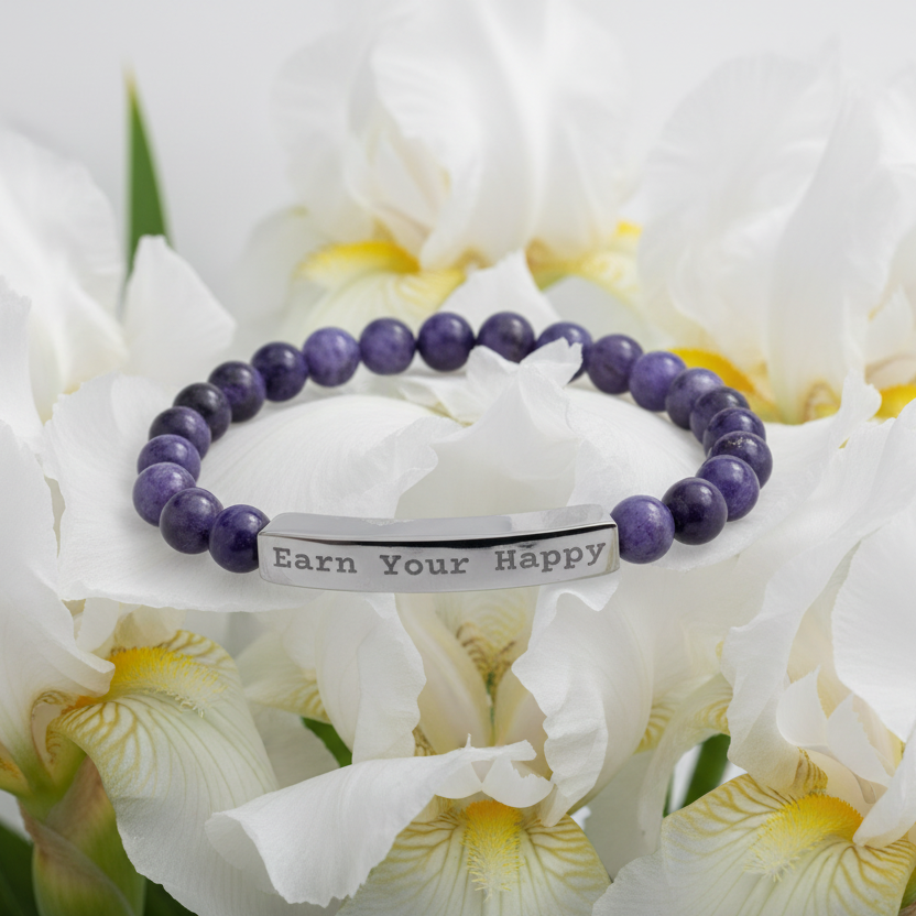 Dark blue natural stone bracelet with message "Earn Your Happy" on white Iris background.