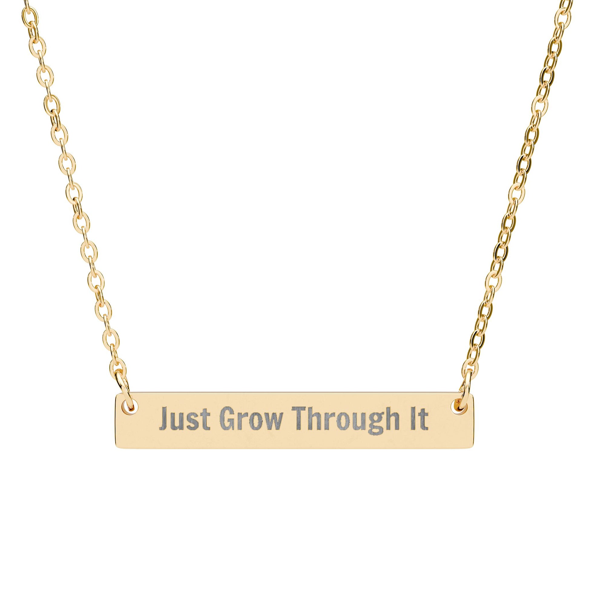 Gold necklace with 'Just Grow Through It' pendant on a white background