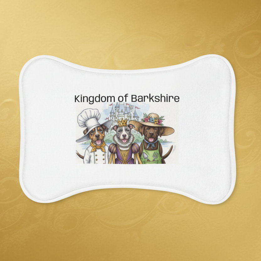 Bone shaped pet feeding mat from the storybook series "The Golden Bone" featuring the Kingdom of Barkshire image of Royal Chef Slim, a Catahoula Leopard Pittie Mix, his sister Queen June, a grey and white pit bull, and their brother, Royal Gardener Hank, a chocolate brown Labrador.