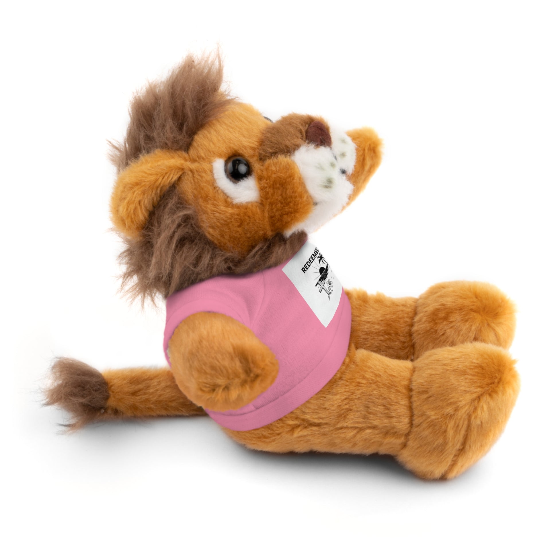 Plush toy lion wearing a pink shirt on a white background