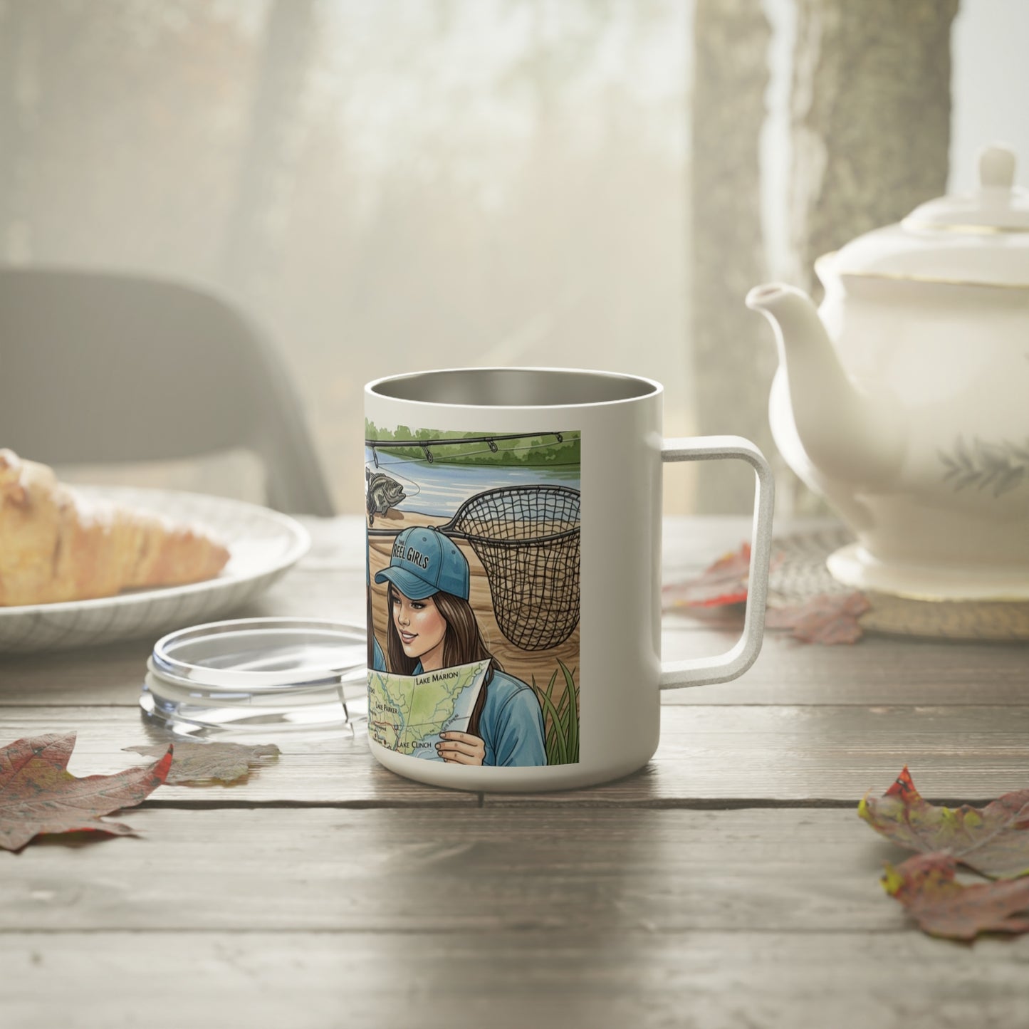 Mug with a design of a woman holding a map and a basket, placed on a table with a teapot and bread in the background.
