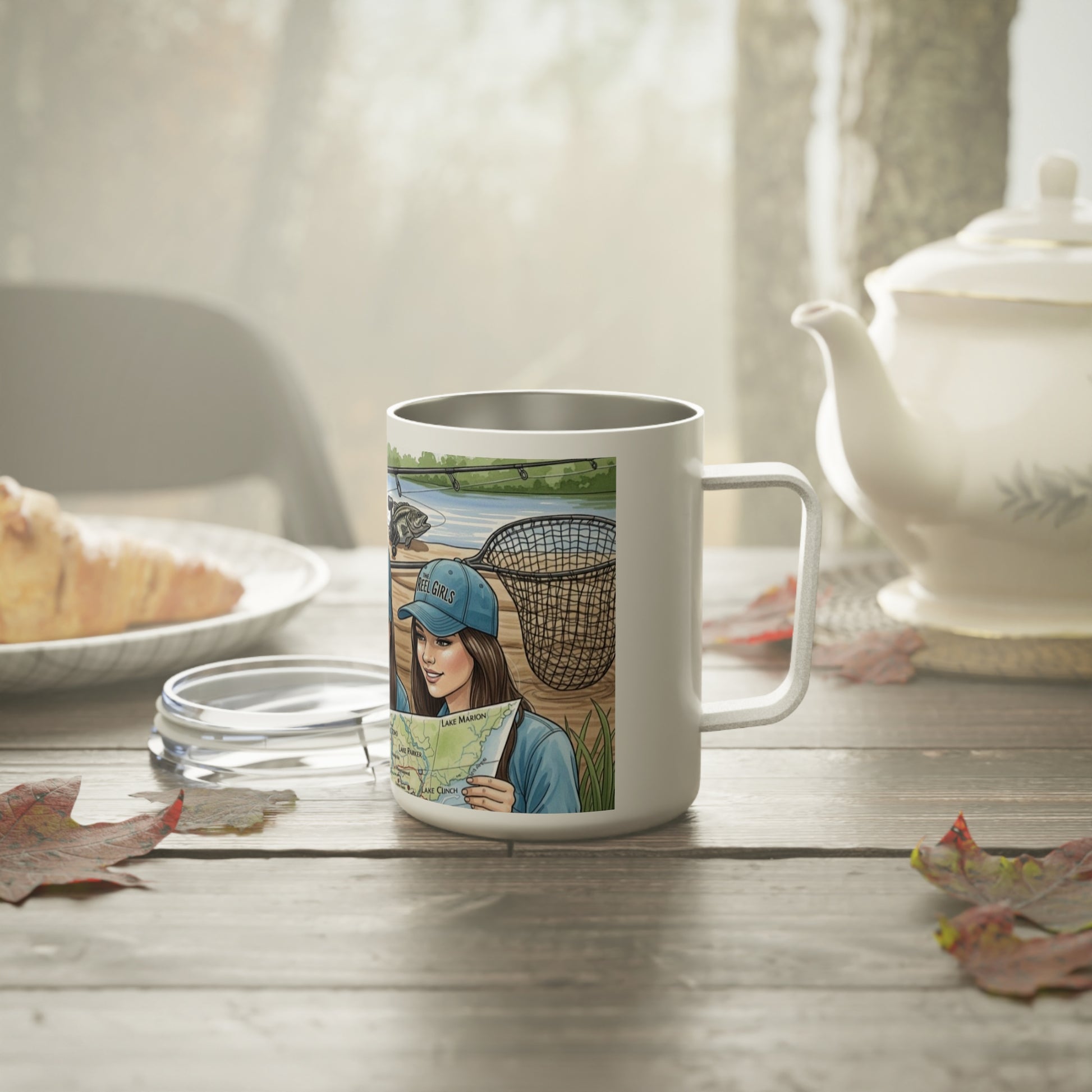 Mug with a design of a woman holding a map and a basket, placed on a table with a teapot and bread in the background.
