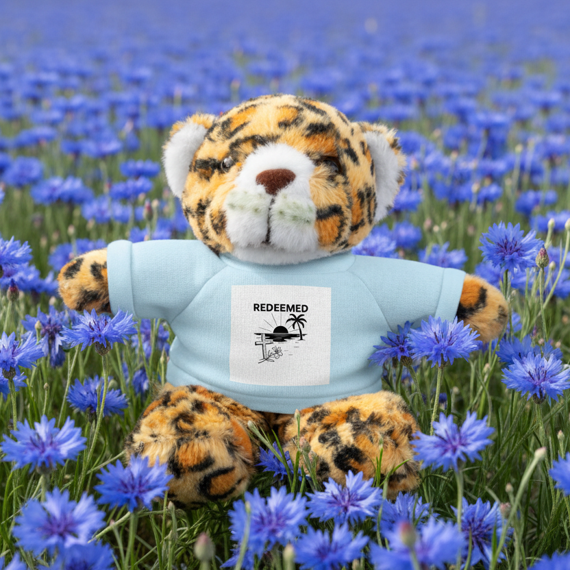 Plush tiger stuffed animal with blue t-shirt Redeemed in a field of blue wildflowers.