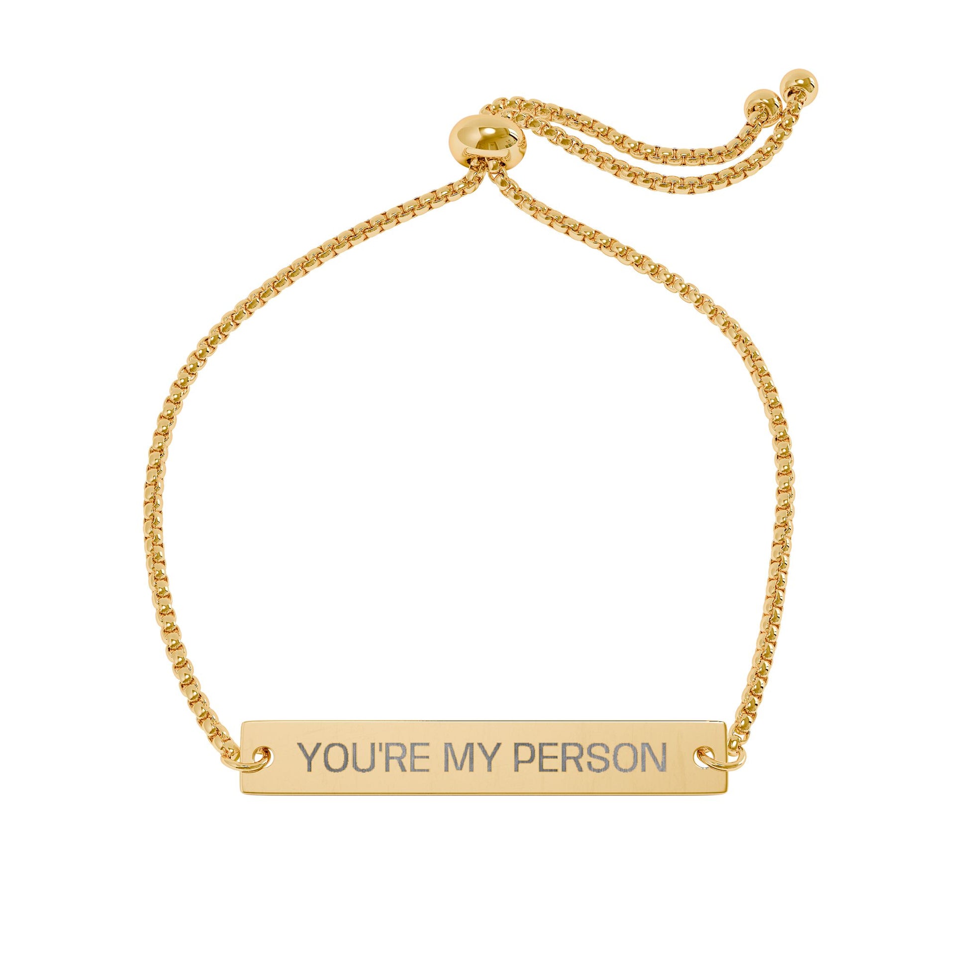 Gold bracelet with 'YOU'RE MY PERSON' engraving on a white background