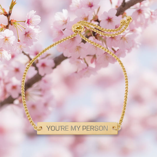 Cherry blooms with a "You're My Person" gold bar slide bracelet