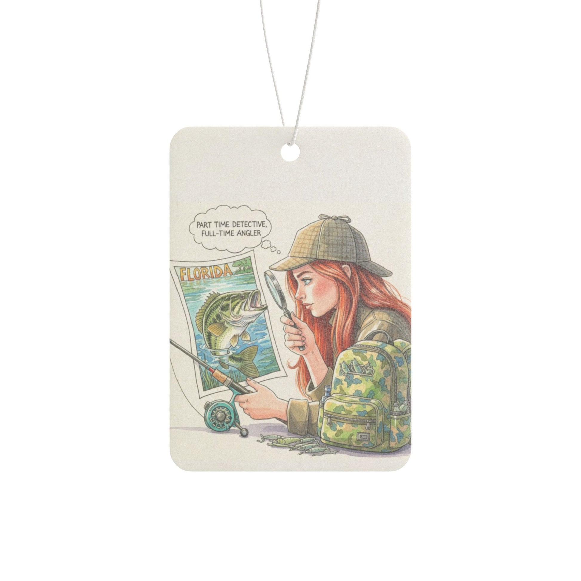 Air freshener with illustration of a person holding a magnifying glass and a map, with text 'Part the detective, full-time angler' on a white background.
