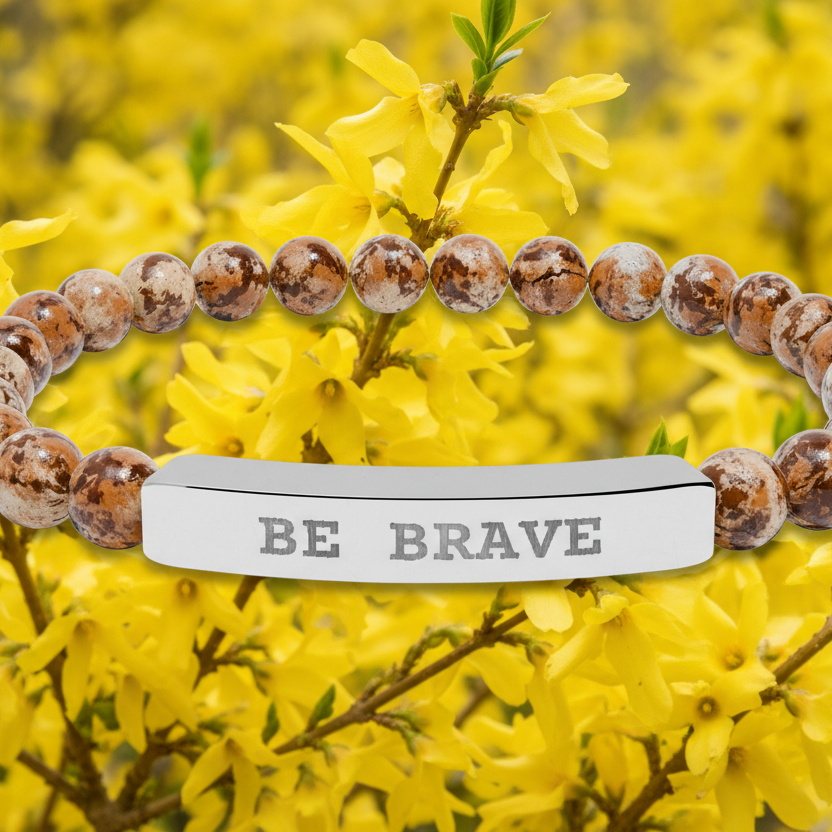 Bracelet with 'BE BRAVE' engraving on yellow floral background