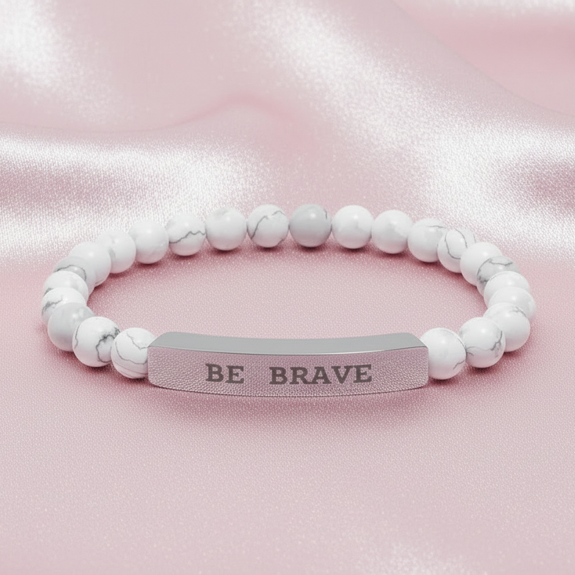 Natural stone beaded bracelet with 'BE BRAVE' silver bar engraved on a pink satin background