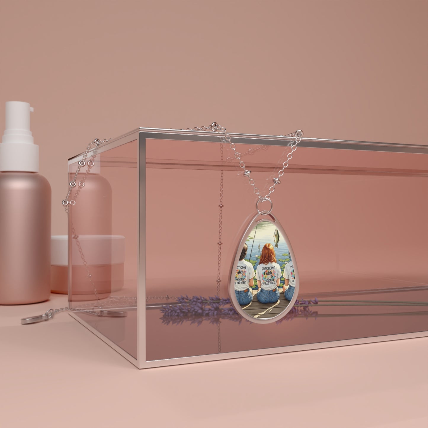 Teardrop-shaped pendant with a scenic design on a pink background