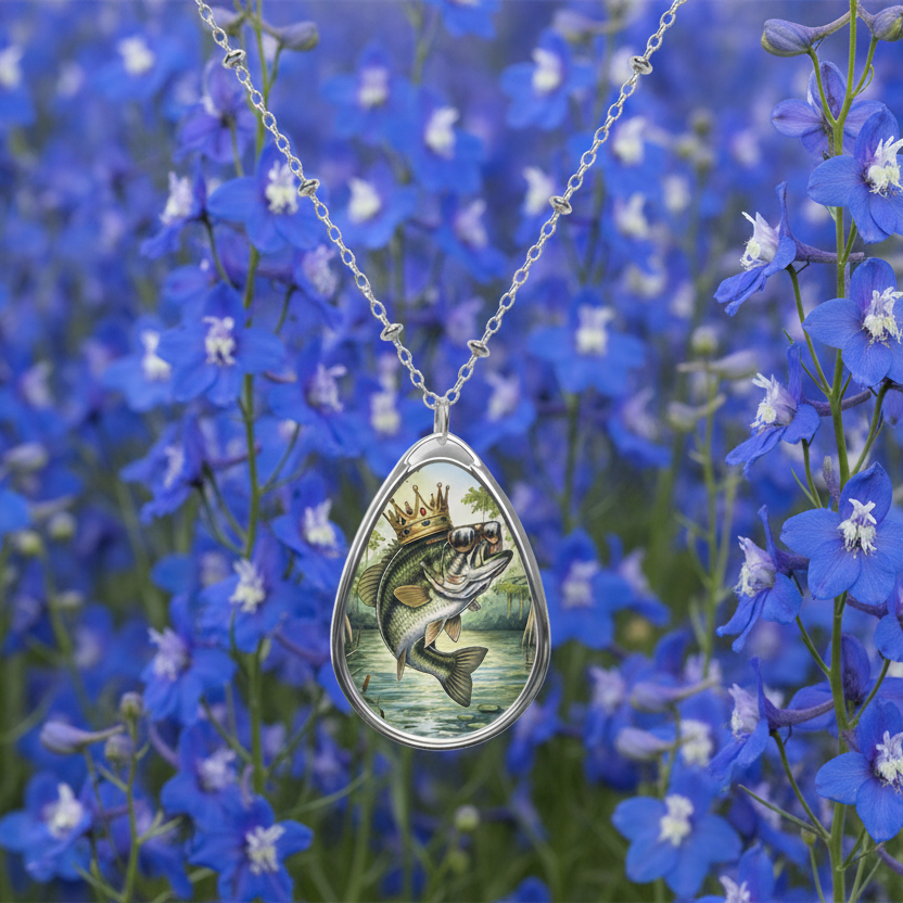Teardrop-shaped pendant with a fish design on a blue Sweet William floral background.