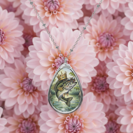 Teardrop-shaped pendant with fish design on a pink floral background with a large mouth bass wearing a crown and sunglasses.