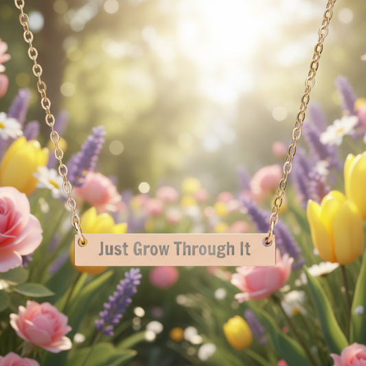 Necklace with 'Just Grow Through It' pendant in a floral setting