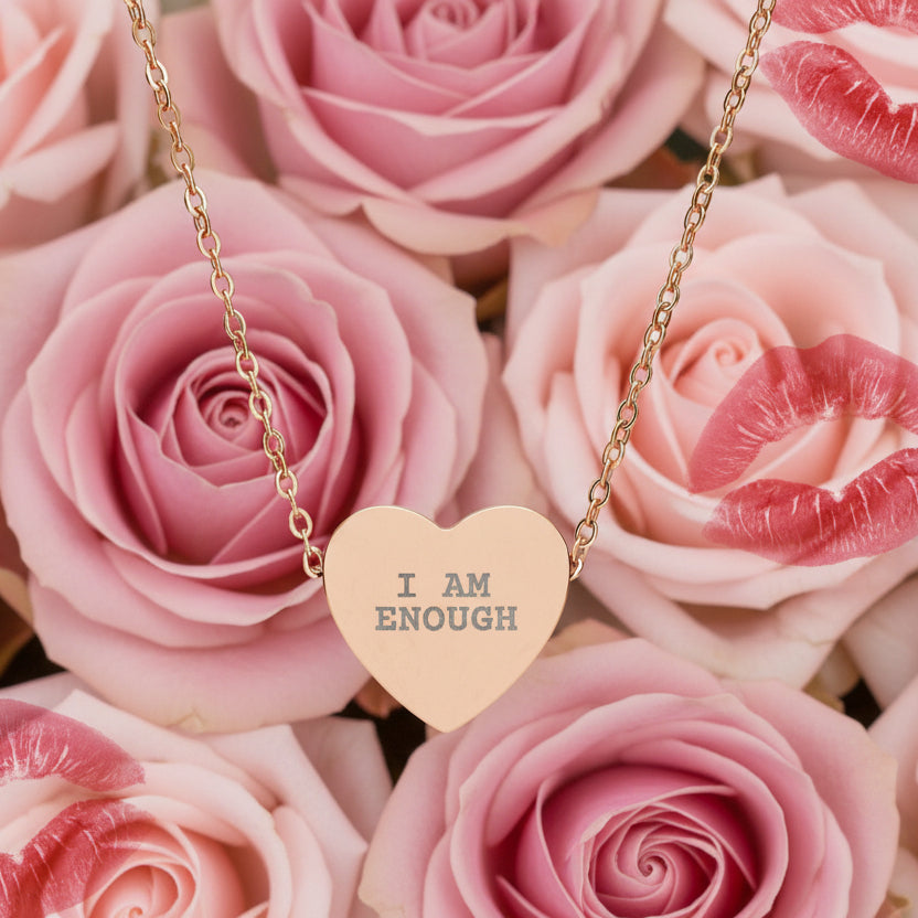Necklace with 'I AM ENOUGH' heart pendant on pink roses