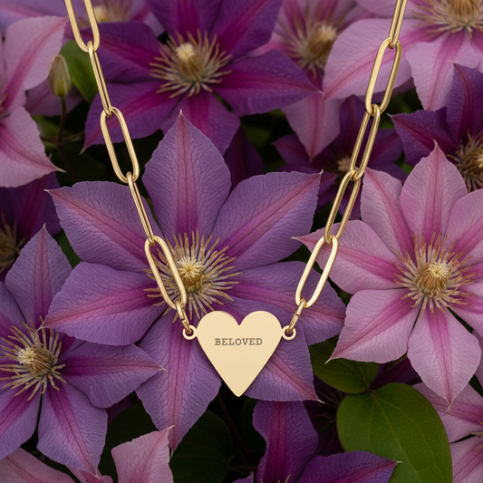 Gold paper clichain necklace with a heart pendant labeled 'BELoved' on purple flower 