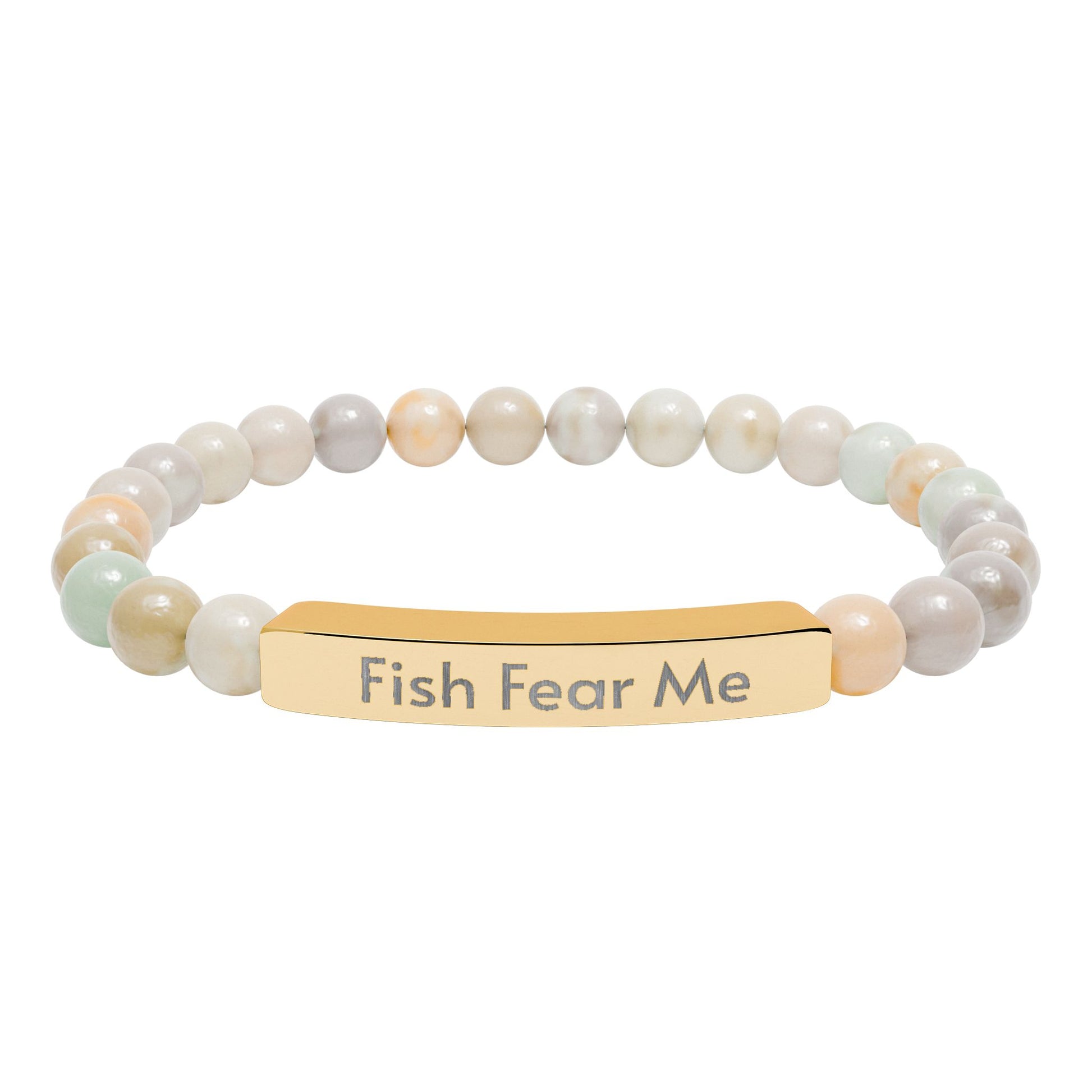Bracelet with beige beads and gold bar with 'Fish Fear Me' engraving on a white background