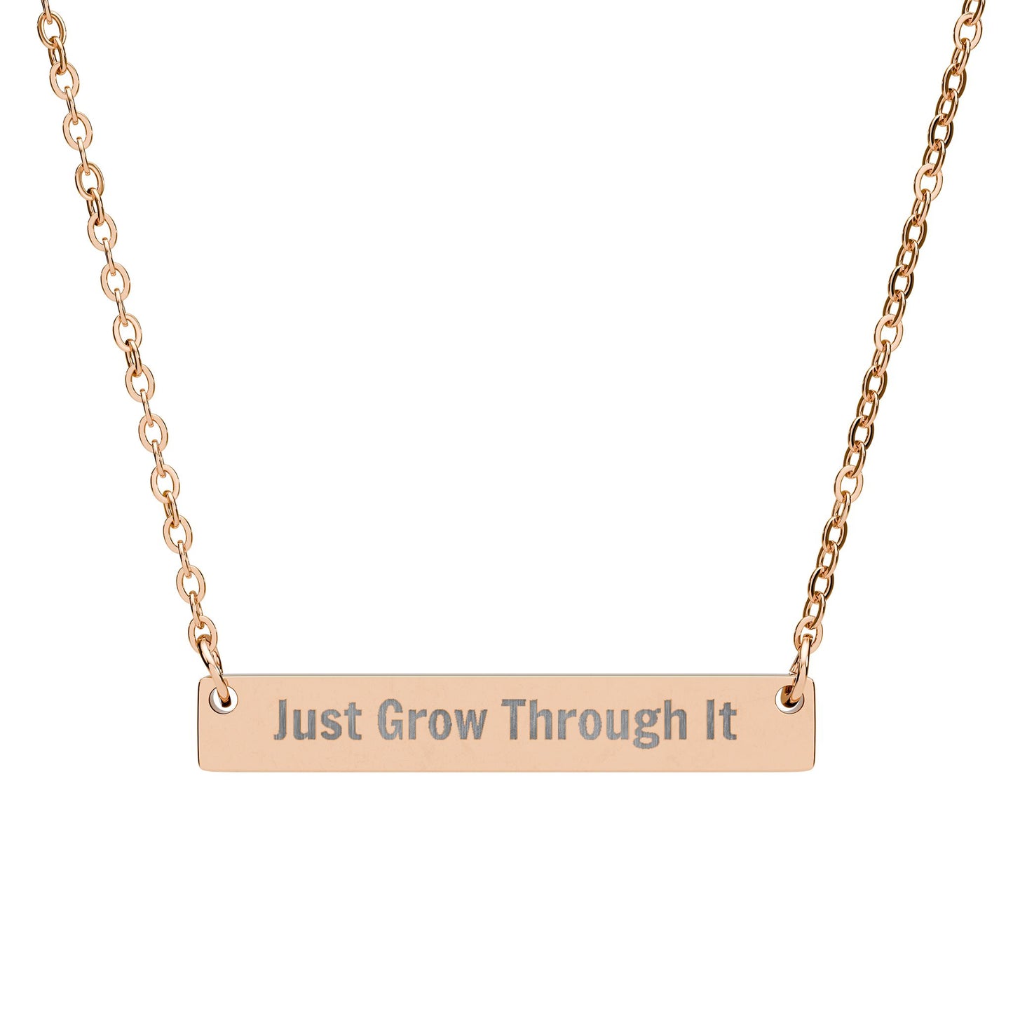 Rose gold necklace with 'Just Grow Through It' engraving on a white background