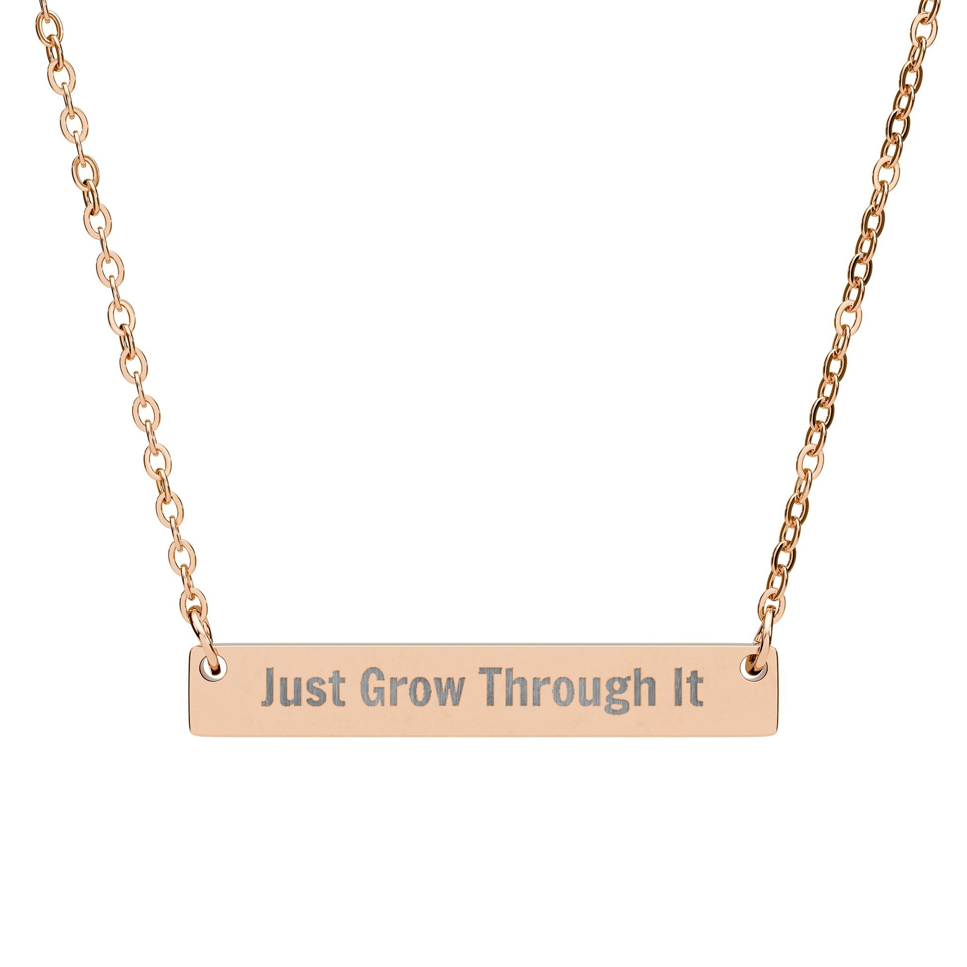 Rose gold necklace with 'Just Grow Through It' engraving on a white background