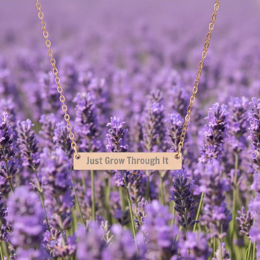 Necklace with 'Just Grow Through It' pendant in a lavender field