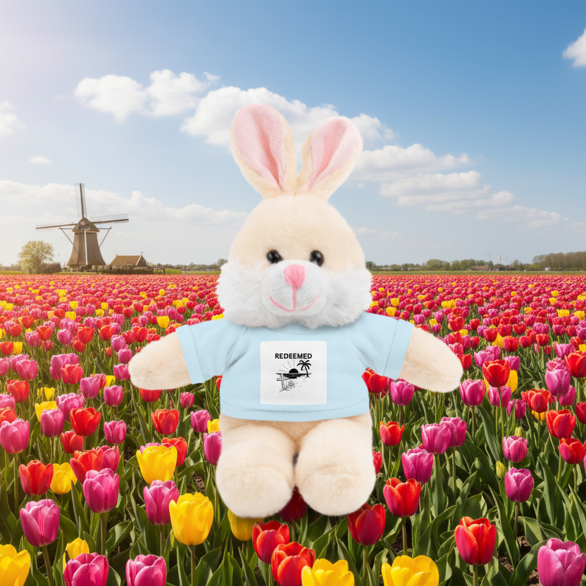 white plush bunny with blue Redeemed t-shirt in field of tulips
