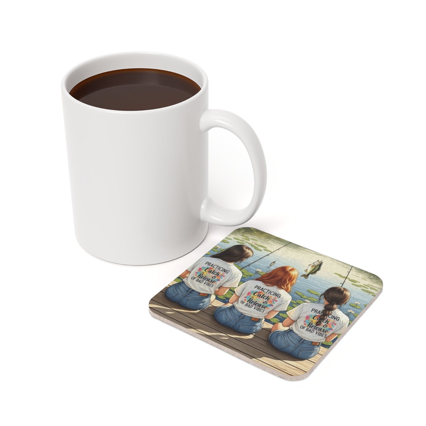 White mug with coffee and a matching coaster with a design of three women fishing on a white background