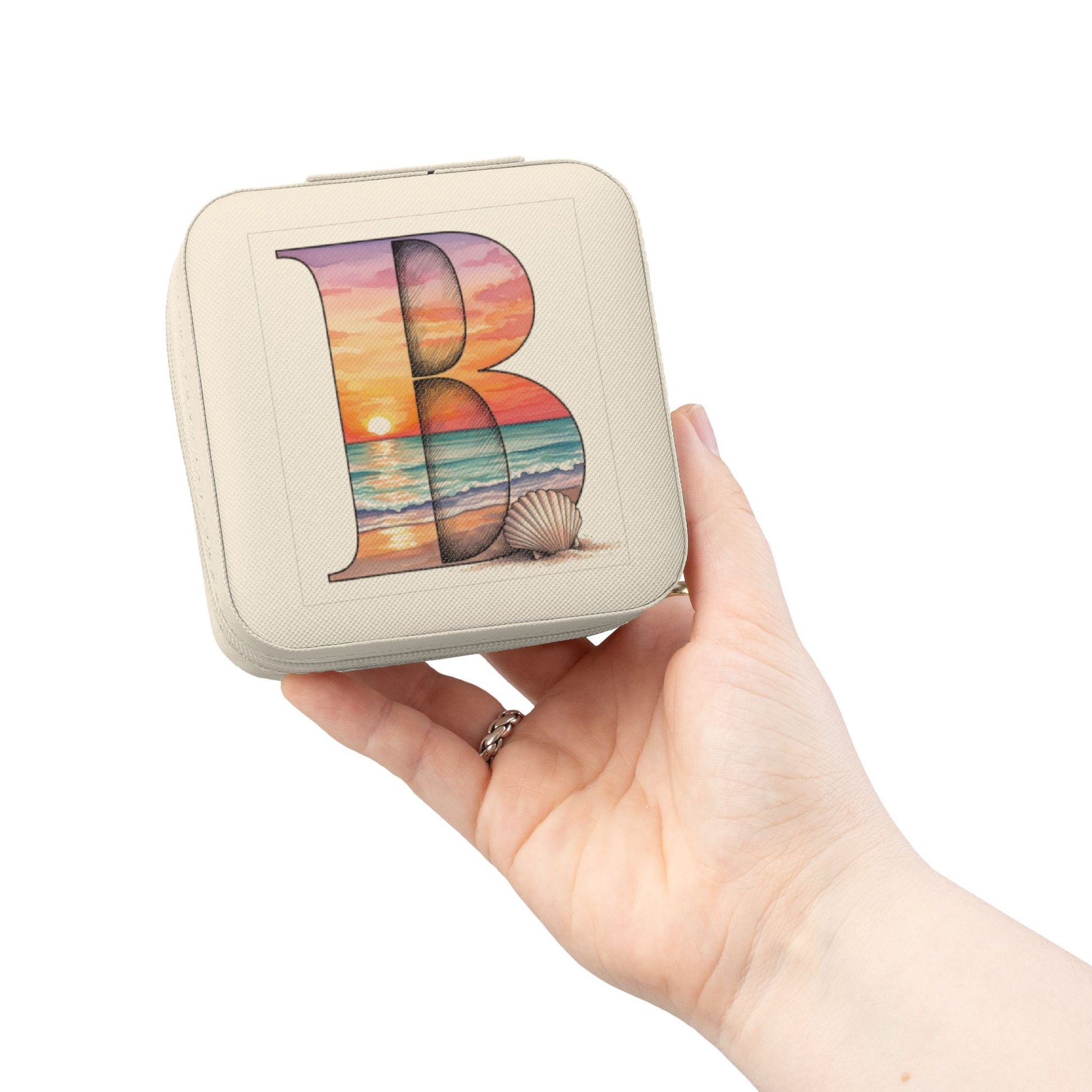Small rectangular pouch with a colorful 'B' design held in a hand against a white background