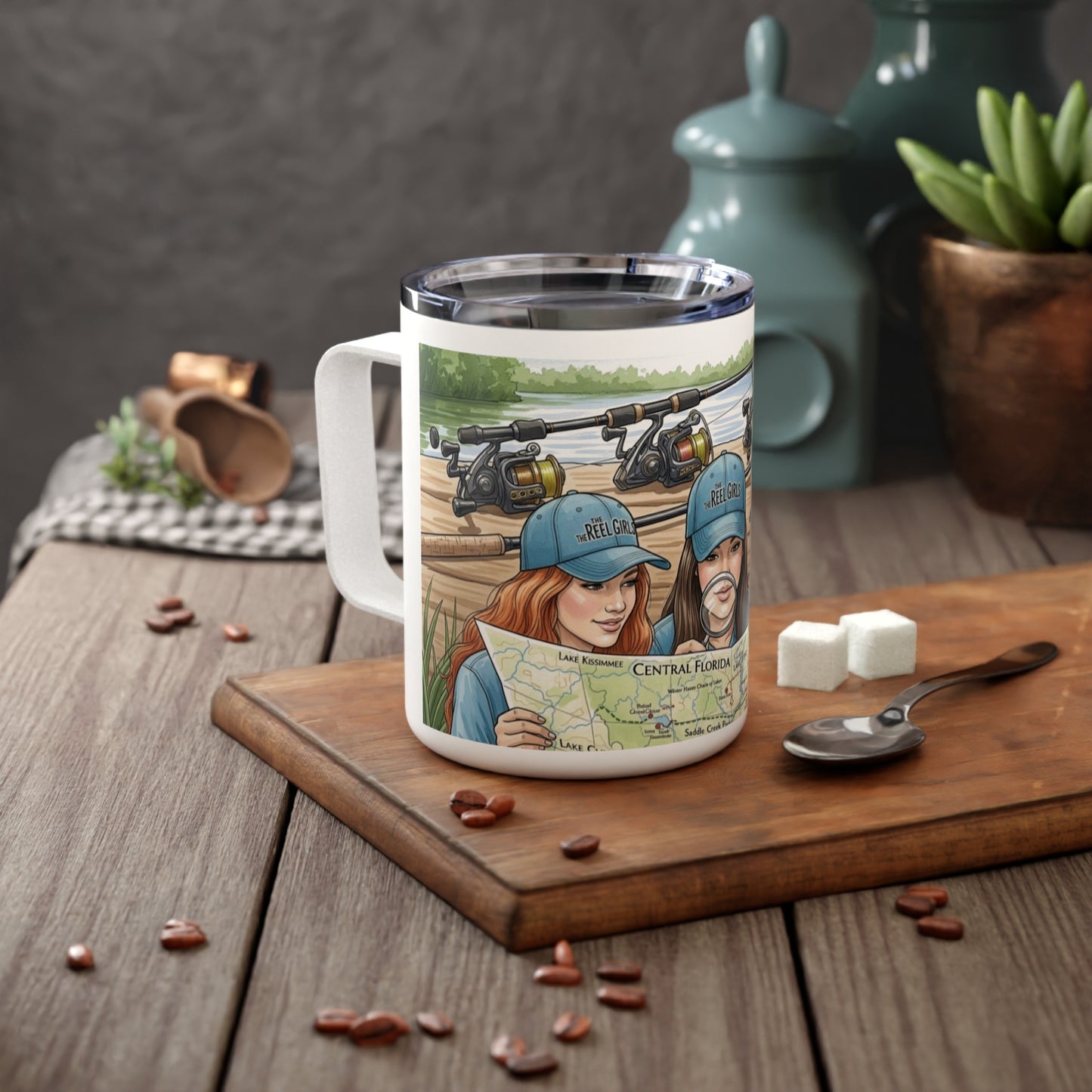 Travel mug with illustration of two people on a lake, surrounded by fishing equipment, on a wooden surface.